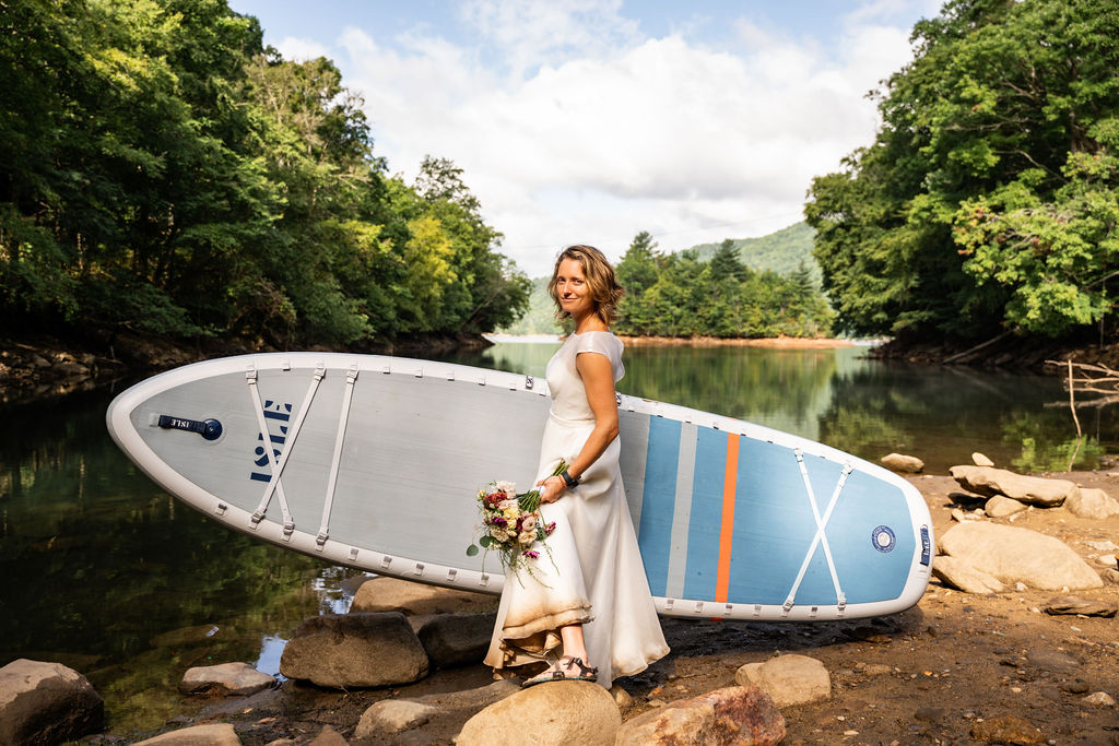 Getting ready to paddle around treasure island for the wedding dress challenge leg 2. The bride, dirty dress and all, will regain the strength to persevere, in her dress. Paddly board in hand, supported by the vision of a life of adventure and love from all angles.