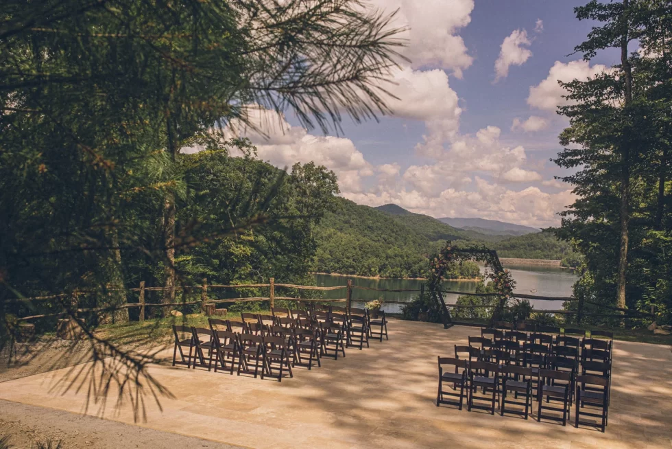 Chairs and arch set up for ceremony at NC wedding venue with mountain views, Lake Nantahala and Smoky Mountains in background